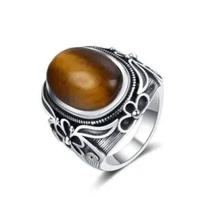 Zilveren ring met tijgeroog en bloemeninleg.